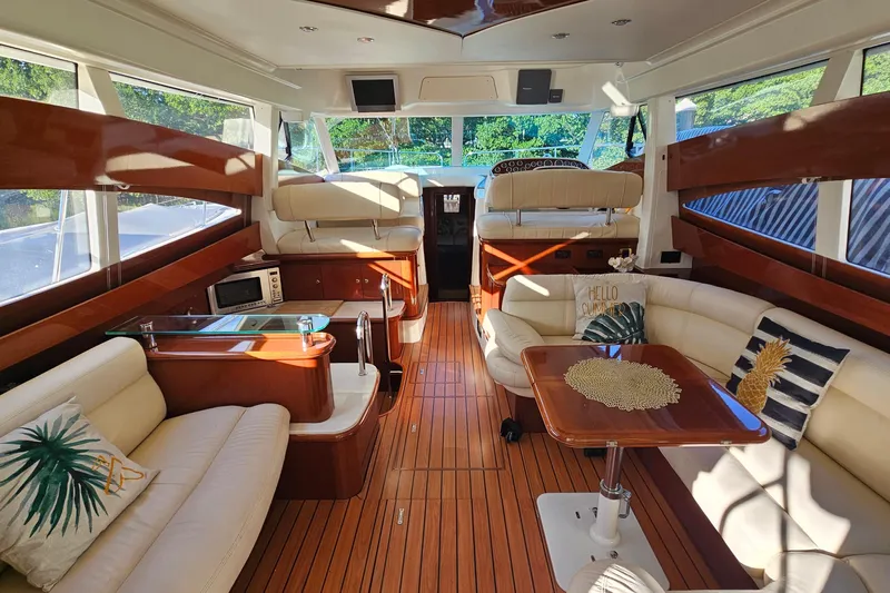Kopara Yacht Photos Pics Luxurious interior of a 2005 Prestige 46 yacht with elegant wood finishes and plush seating.