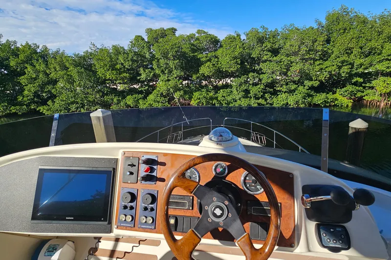 Kopara Yacht Photos Pics Cockpit view of 2005 Prestige 46 yacht with steering wheel and navigation controls.