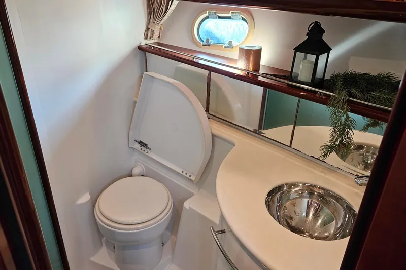 Kopara Yacht Photos Pics Luxurious 2005 Prestige 46 yacht bathroom with toilet, sink, and decorative elements.