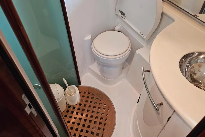 Kopara Yacht Photos Pics Bathroom interior of a 2005 Prestige 46 yacht with toilet and sink.