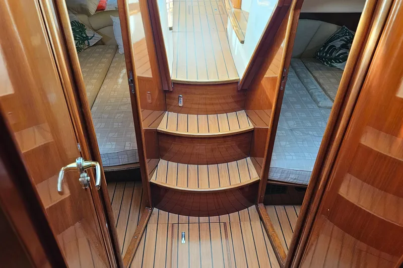 Kopara Yacht Photos Pics Luxurious wooden interior of a 2005 Prestige 46 yacht with elegant stairs and cozy cabins.