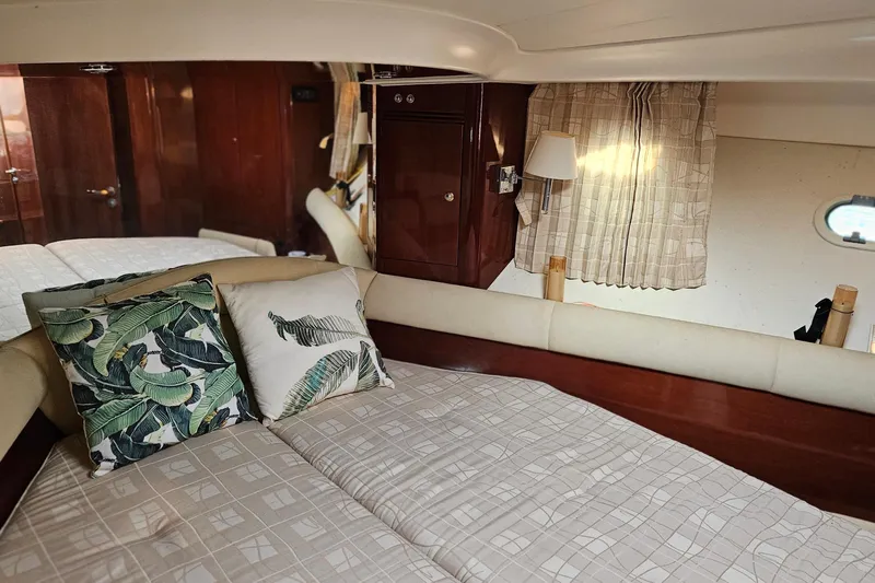 Kopara Yacht Photos Pics Luxurious cabin interior of a 2005 Prestige 46 yacht with elegant bedding and decor.