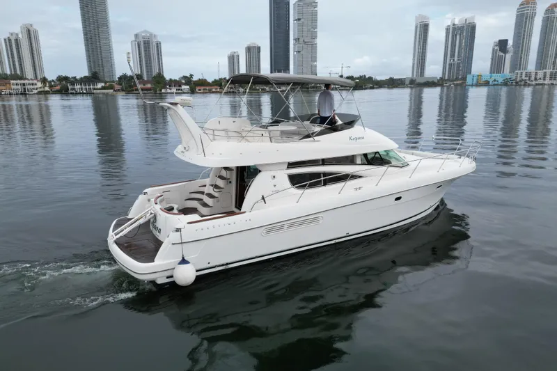 Kopara Yacht Photos Pics 2005 Prestige 46 yacht cruising near city skyline on calm water.