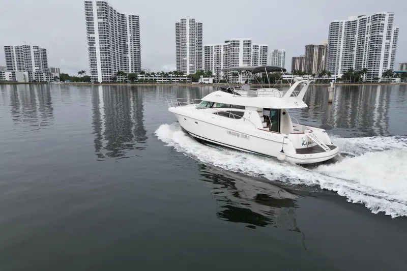 Kopara Yacht Photos Pics Prestige 46 yacht cruising near modern high-rise buildings, 2005 model.