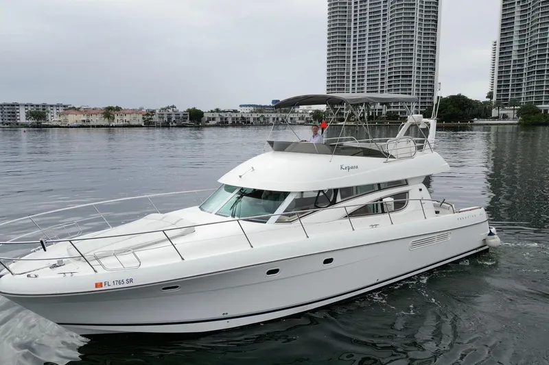 Kopara Yacht Photos Pics 2005 Prestige 46 yacht cruising near urban waterfront with high-rise buildings.