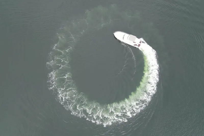 Kopara Yacht Photos Pics Aerial view of 2005 Prestige 46 yacht making a circular wake in the water.