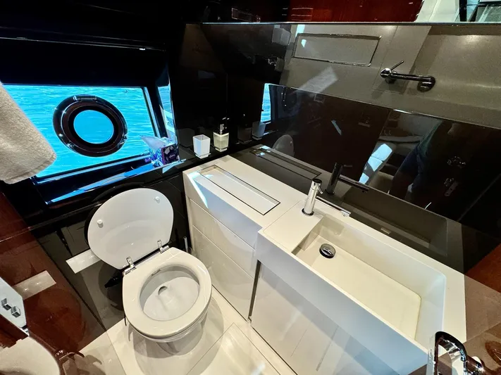 Grey Yacht Photos Pics Luxurious bathroom in 2021 Riva 56 Rivale yacht with modern fixtures and ocean view.