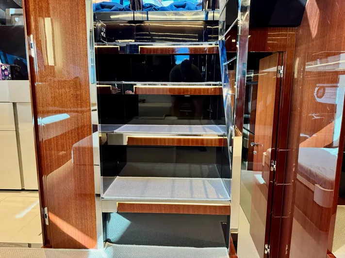 Grey Yacht Photos Pics Interior staircase of 2021 Riva 56 Rivale yacht, featuring sleek wood and metal design.