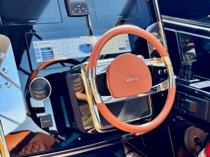 Grey Yacht Photos Pics Steering wheel of 2021 Riva 56 Rivale yacht with modern dashboard controls.