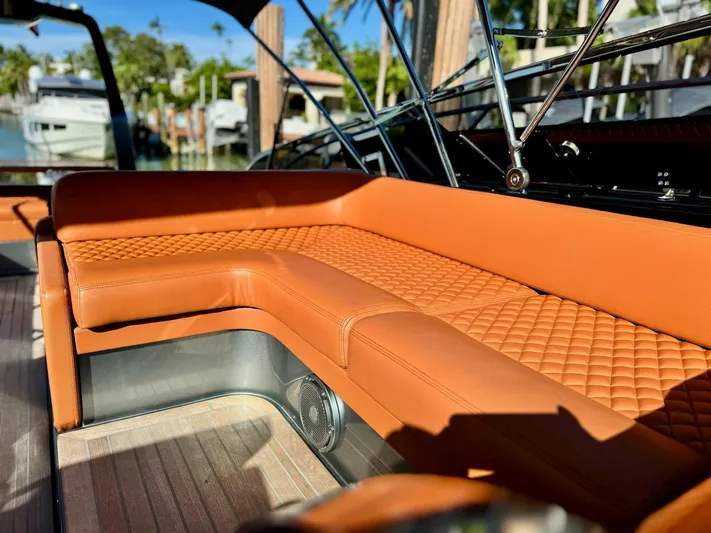 Grey Yacht Photos Pics Luxurious leather seating on 2021 Riva 56 Rivale yacht, docked with scenic marina view.
