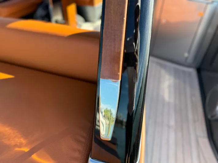 Grey Yacht Photos Pics Close-up of 2021 Riva 56 RIVALE yacht interior with leather seating and sleek metal detail.