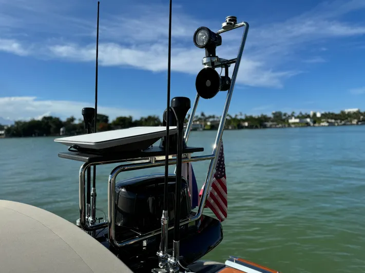 Grey Yacht Photos Pics Riva 56 RIVALE 2021 yacht detail with antennas and American flag on a sunny day.