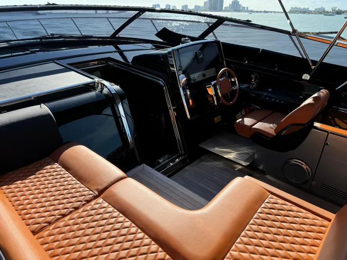 Grey Yacht Photos Pics Luxurious interior of 2021 Riva 56 Rivale yacht with leather seating and modern dashboard.