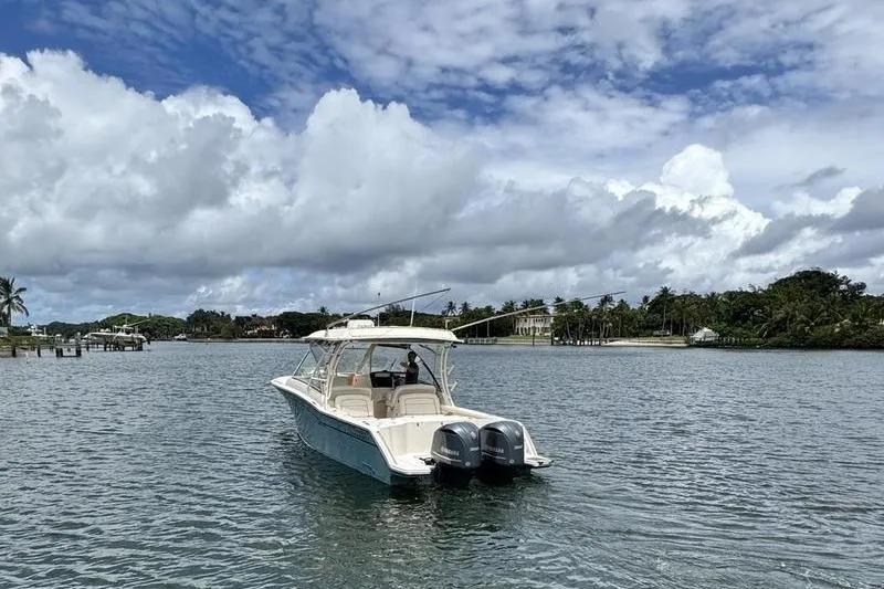  Yacht Photos Pics 2018 Grady-White Freedom 325 boat on calm water under cloudy sky.