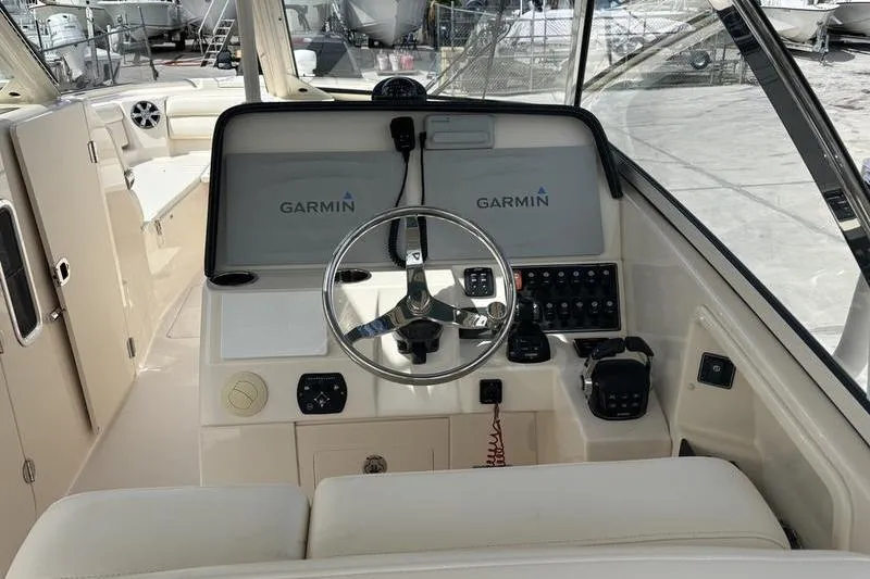  Yacht Photos Pics 2018 Grady-White Freedom 325 boat helm with Garmin navigation system and steering wheel.