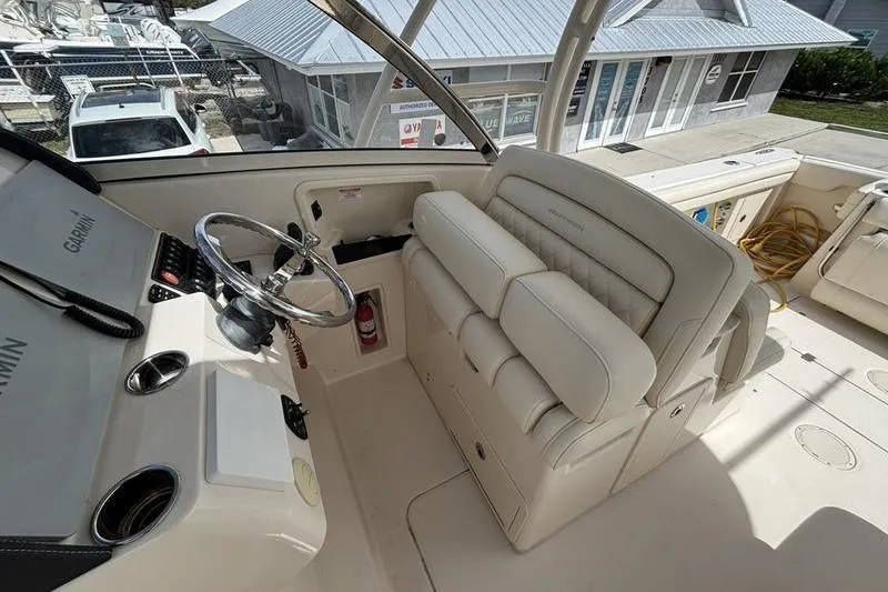  Yacht Photos Pics Helm of 2018 Grady-White Freedom 325 boat with steering wheel and seating.