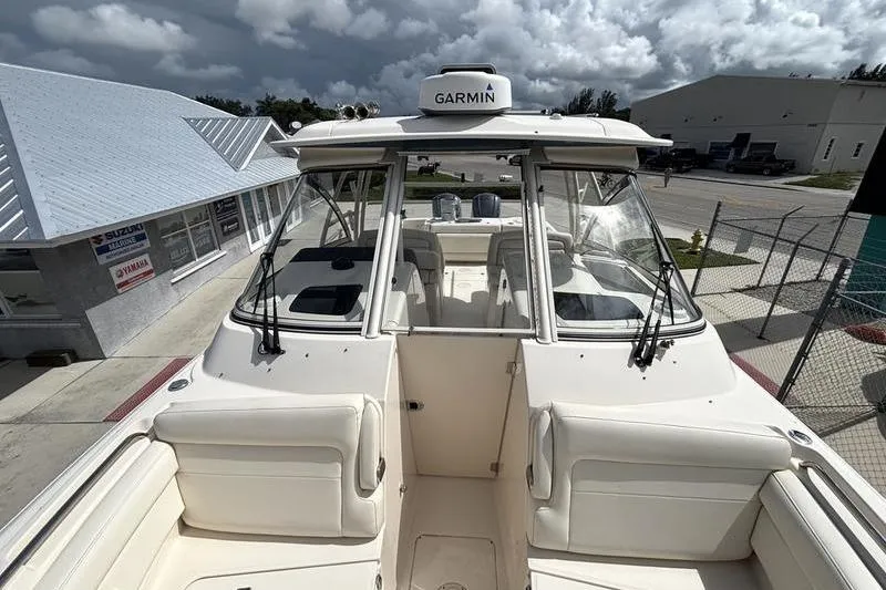  Yacht Photos Pics 2018 Grady-White Freedom 325 boat with Garmin equipment, docked under cloudy skies.