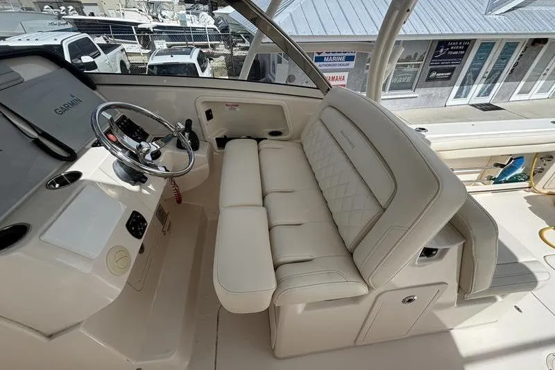  Yacht Photos Pics 2018 Grady-White Freedom 325 boat interior with steering wheel and cushioned seating.