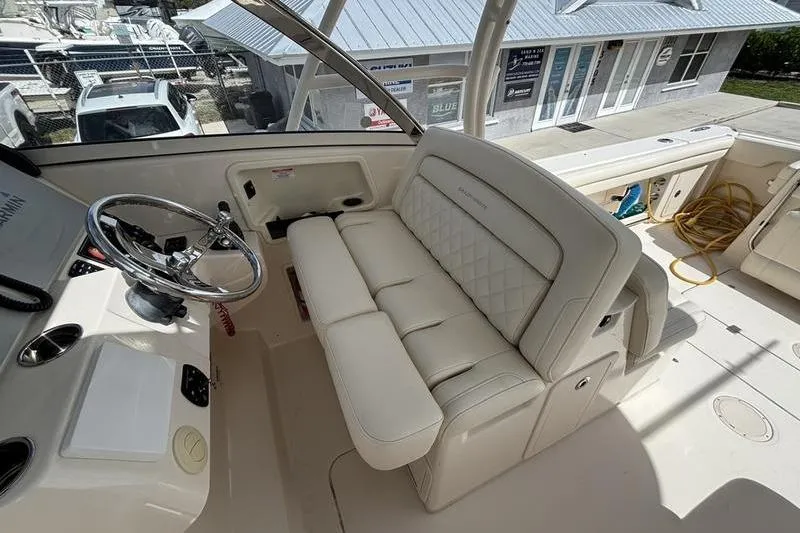  Yacht Photos Pics 2018 Grady-White Freedom 325 boat interior with steering wheel and cushioned seating.