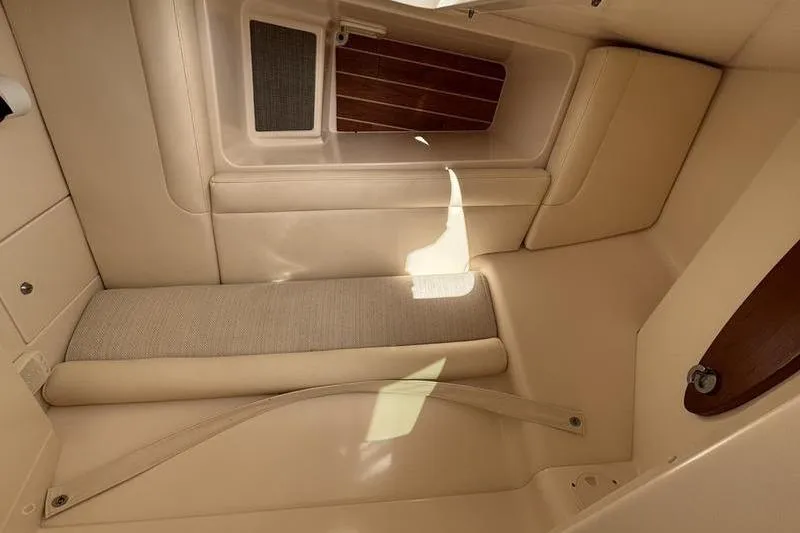  Yacht Photos Pics Interior cabin of 2018 Grady-White Freedom 325 boat, featuring beige upholstery and wooden accents.