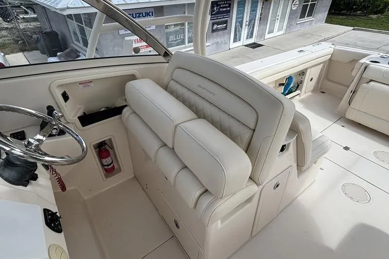  Yacht Photos Pics 2018 Grady-White Freedom 325 boat interior with steering wheel and cushioned seating.