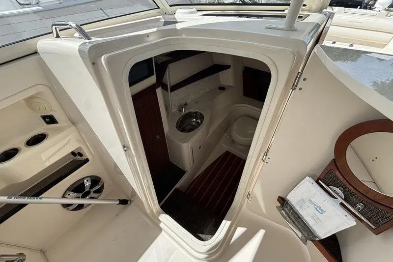  Yacht Photos Pics 2018 Grady-White Freedom 325 boat interior with compact bathroom and sink.