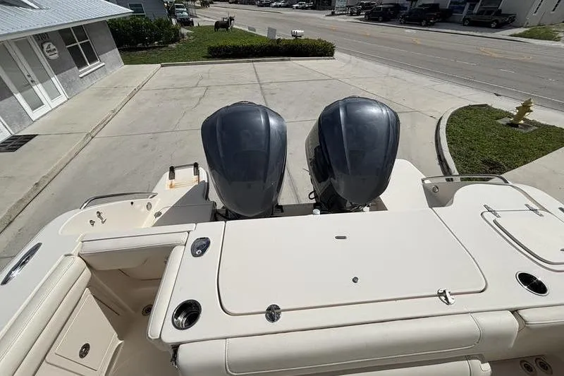  Yacht Photos Pics 2018 Grady-White Freedom 325 boat with dual outboard engines, docked on a sunny day.