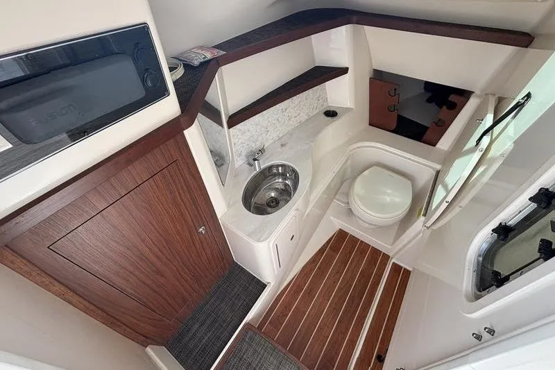  Yacht Photos Pics 2018 Grady-White Freedom 325 boat interior with sink, toilet, and wood accents.