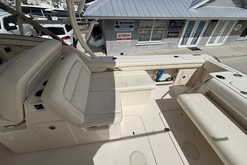 Yacht Photos Pics 2018 Grady-White Freedom 325 boat interior with beige seating and marine dealership background.