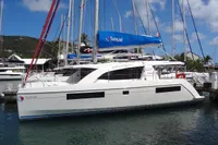 2020 Leopard 40 catamaran docked, featuring a blue Sunsail sail, under a clear sky.