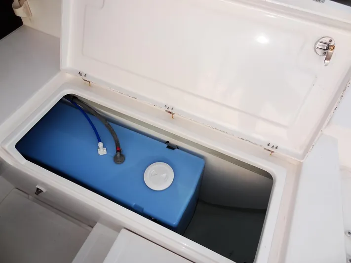 Anchor Beer Yacht Photos Pics Open storage compartment on 2020 Leopard 40 boat with blue tank inside.