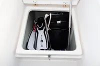 Storage compartment on a 2020 Leopard 40 with diving fins, rope, and buckets.