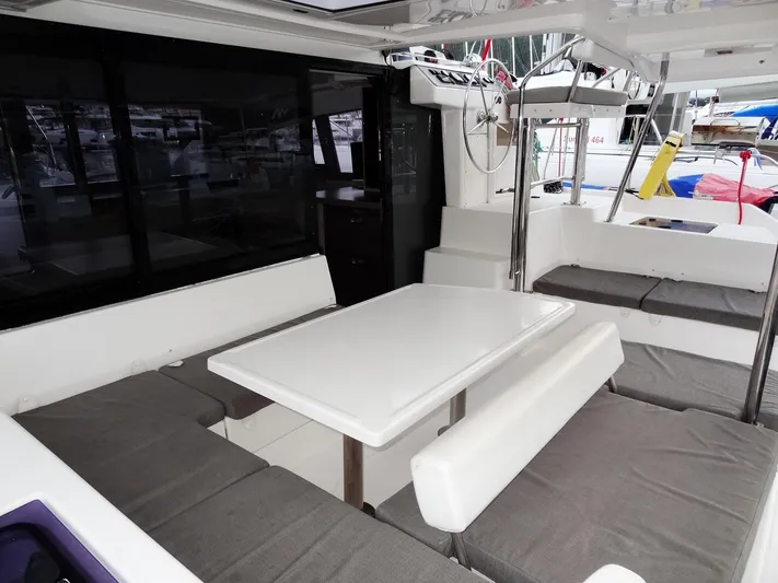 Anchor Beer Yacht Photos Pics Spacious seating area on a 2020 Leopard 40 catamaran with cushioned benches and a central table.