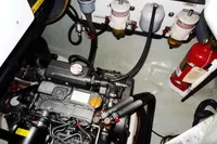 Engine room of 2020 Leopard 40 catamaran with visible engine, filters, and fire extinguisher.