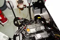Engine compartment of a 2020 Leopard 40 catamaran, featuring mechanical components and a fire extinguisher.