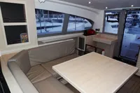 Modern interior of 2020 Leopard 40 catamaran with dining area and large windows.