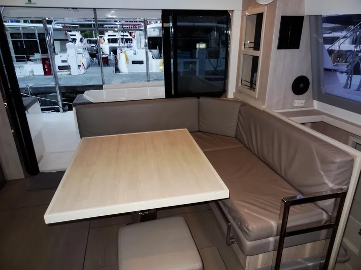 Anchor Beer Yacht Photos Pics Interior of a 2020 Leopard 40 yacht with a cozy dining area and marina view.
