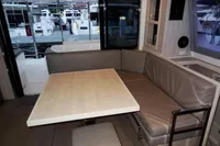Interior of a 2020 Leopard 40 yacht with a cozy dining area and marina view.