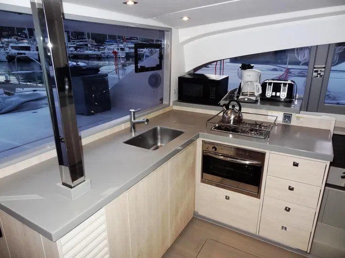 Anchor Beer Yacht Photos Pics Modern kitchen interior on a 2020 Leopard 40 yacht with appliances and marina view.