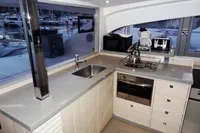 Modern kitchen interior on a 2020 Leopard 40 yacht with appliances and marina view.