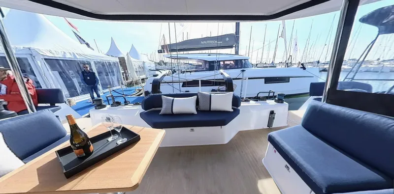 Good Wibe Yacht Photos Pics 2024 Nautitech 48 Open yacht interior with elegant seating and table setup.