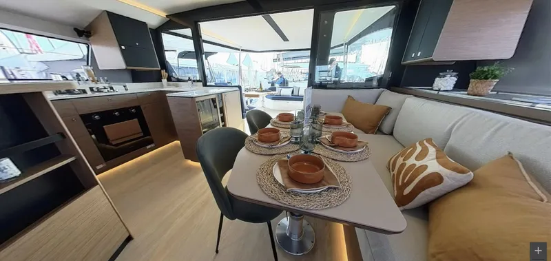 Good Wibe Yacht Photos Pics Luxurious interior of 2024 Nautitech 48 Open catamaran with elegant dining setup.