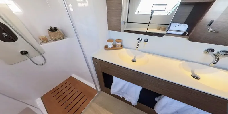 Good Wibe Yacht Photos Pics Luxurious bathroom in 2024 Nautitech 48 Open yacht with modern fixtures and wooden accents.