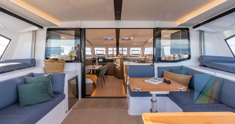 Good Wibe Yacht Photos Pics Luxurious interior of 2024 Nautitech 48 Open yacht with modern seating and dining area.