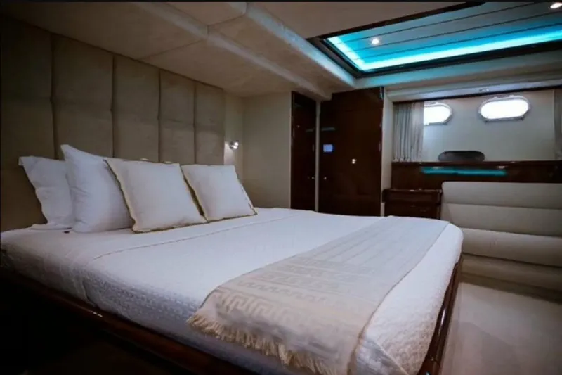 Hasard Yacht Photos Pics Luxurious bedroom interior of 2002 Ferretti Yachts 720 with elegant bedding and ambient lighting.