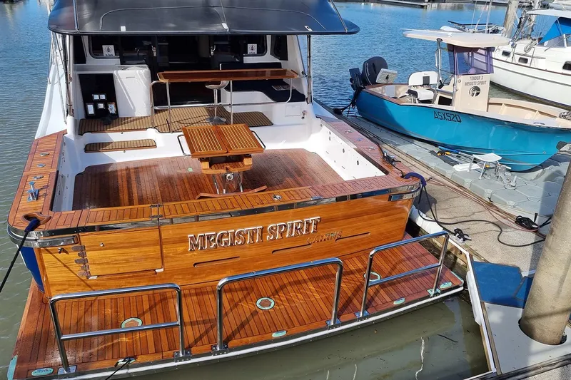 Megisti Spirit Yacht Photos Pics 2008 Westcoaster 70 Flybridge Cruiser docked, featuring polished wood deck and elegant design.