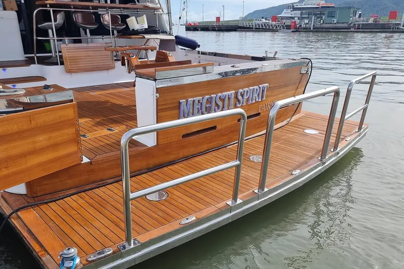 Megisti Spirit Yacht Photos Pics 2008 Westcoaster 70 Flybridge Cruiser with wooden deck and metal railings, docked at a marina.