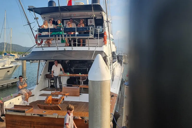 Megisti Spirit Yacht Photos Pics People enjoying on a 2008 Westcoaster 70 Flybridge Cruiser docked at a marina.