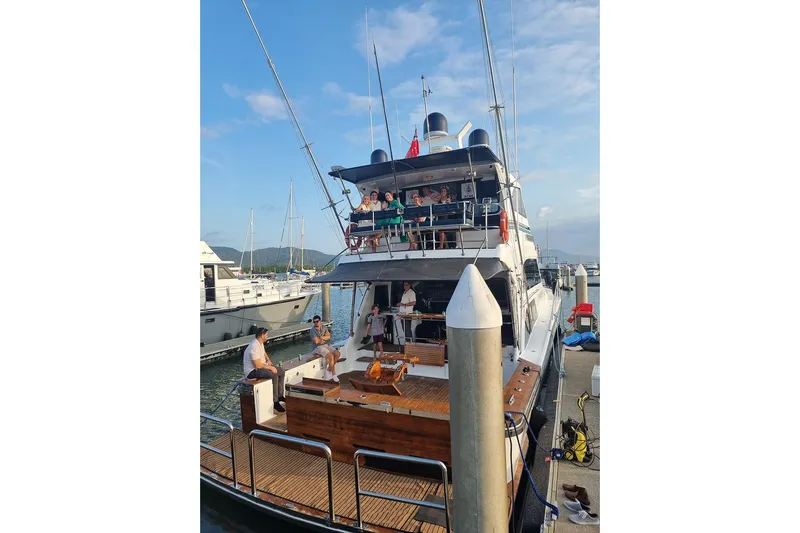 Megisti Spirit Yacht Photos Pics 2008 Westcoaster 70 Flybridge Cruiser docked, with people enjoying the deck under a clear sky.