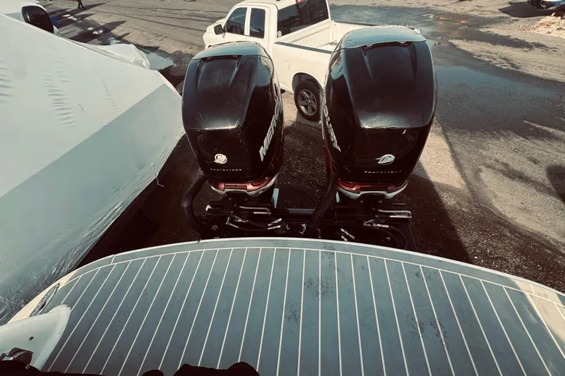  Yacht Photos Pics 2019 Formula 310 FX Bowrider with dual Mercury outboard engines, parked near a white truck.